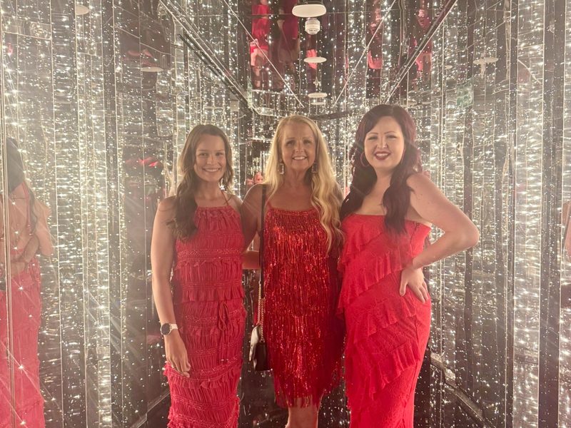 Kaitlin with family at Scarlet Night on Virgin Voyages